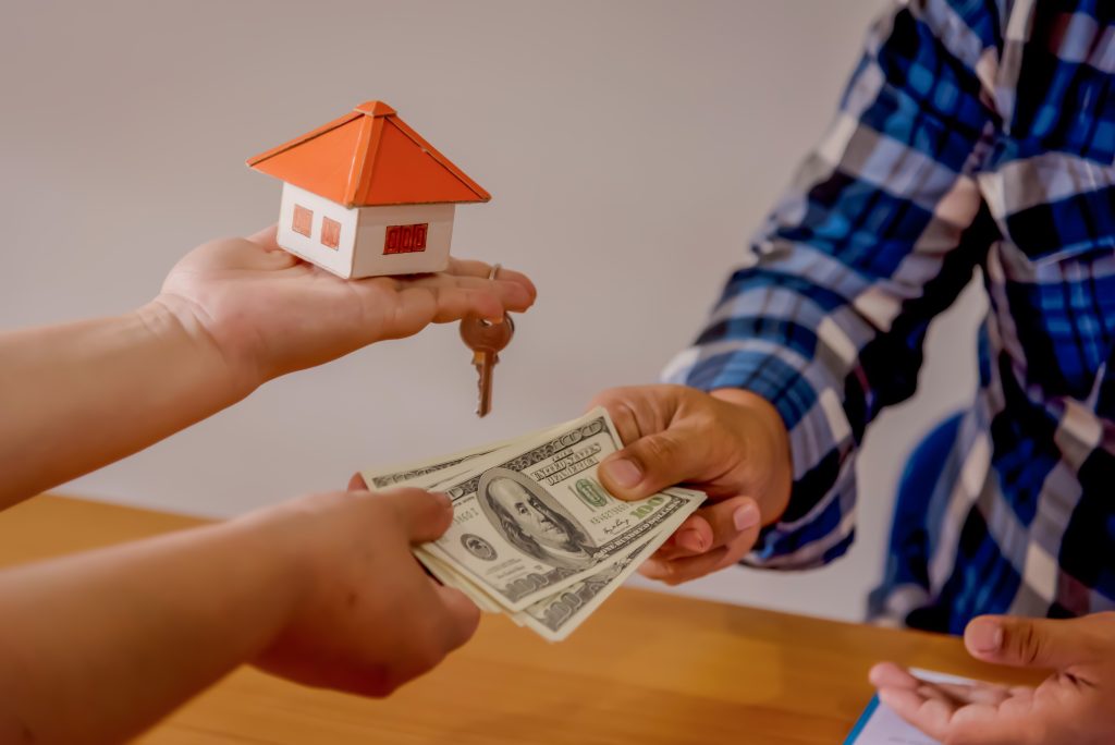 selling real estate concept with a house and key
